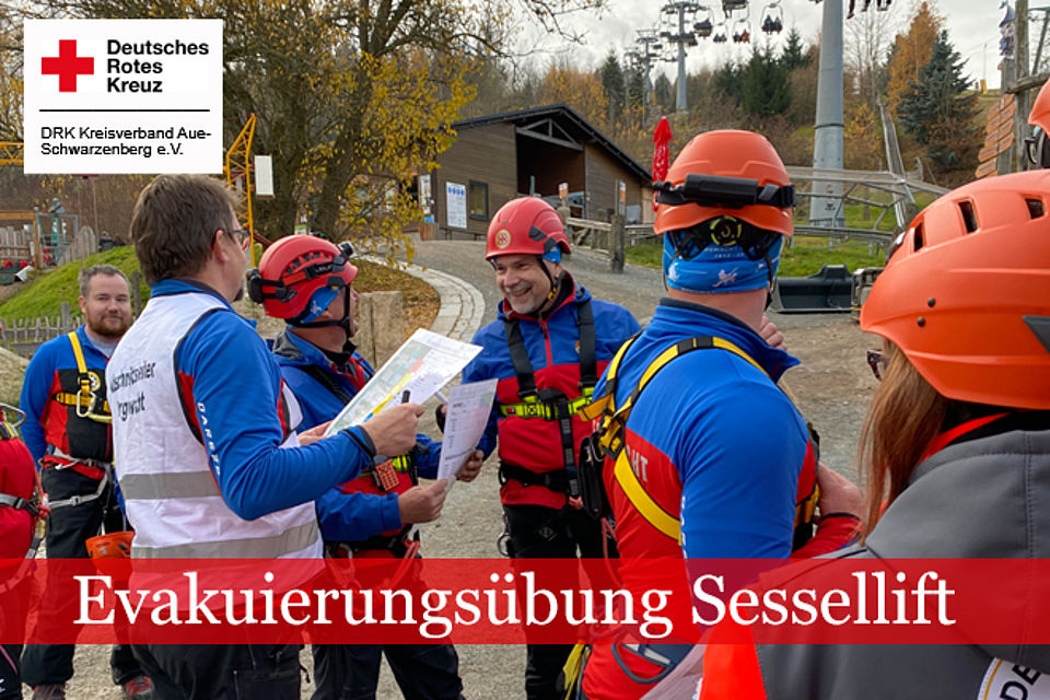 Einweisung vor dem EinsatzEinsatzleiter mit Dokumenten in der Hand wendet sich an Mitglieder der Bergwacht.